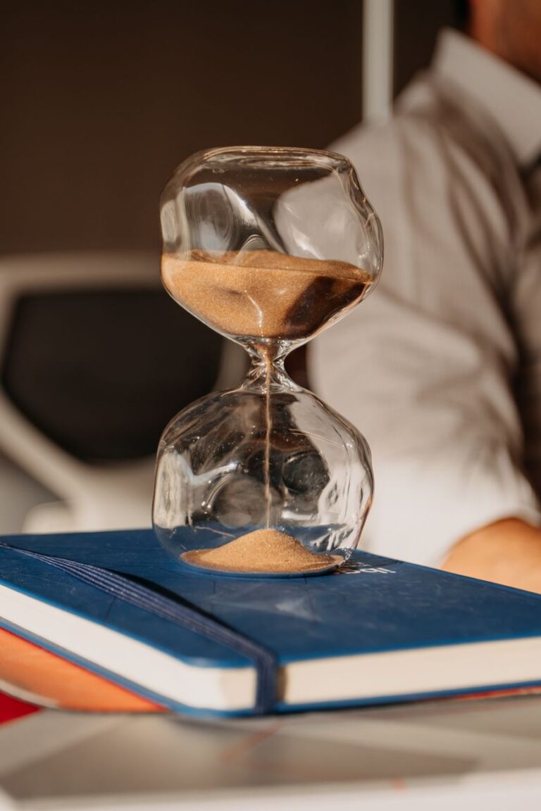 hourglass on books in an office setting
